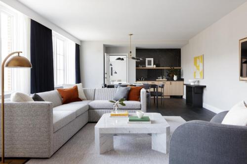 a living room with a couch and a table at Kimpton - The Forum Hotel by IHG in Charlottesville