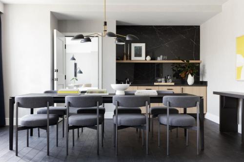 a dining room with a black table and chairs at Kimpton - The Forum Hotel by IHG in Charlottesville