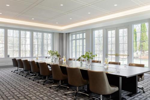 a large conference room with a long table and chairs at Kimpton - The Forum Hotel by IHG in Charlottesville