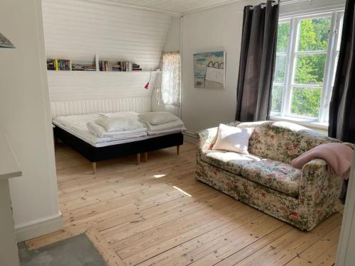 a living room with a couch and a bed at Mysigt hus för 2 familjer in Västervik