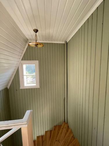 a room with a ceiling with a window and a fan at Mysigt hus för 2 familjer in Västervik