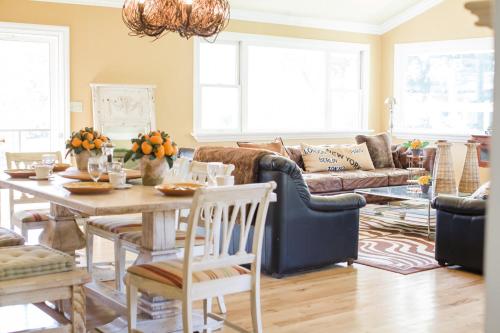 a living room with a table and a couch at Napa Farmhouse Inn in St. Helena