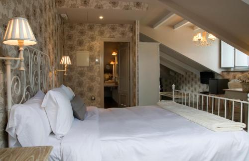 a bedroom with a large white bed in a room at Casona Naviega in Navia