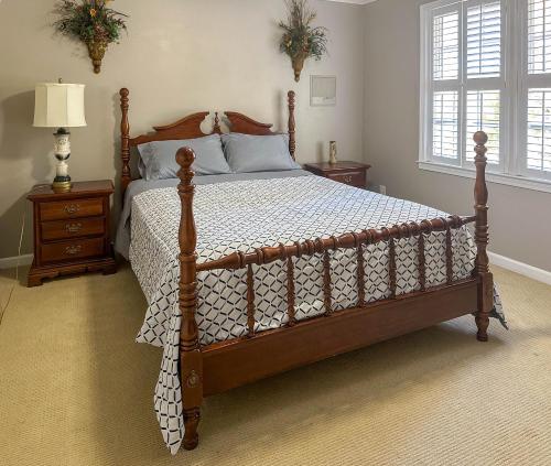 a bedroom with a wooden bed with a wooden frame at Southern Home and fishing lake. in Gainesville