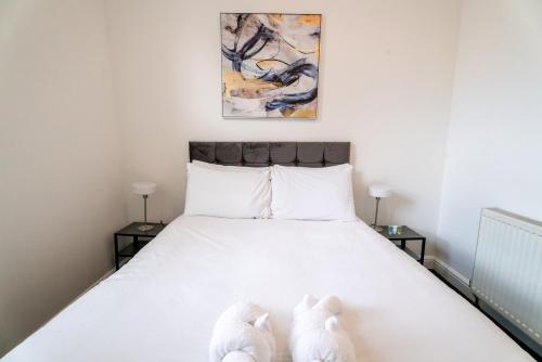 dos animales de peluche sentados en una cama en un dormitorio en Cozy Urban - Retreat Modern 1BR - Free Parking, en Bristol