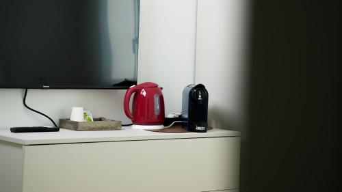 a red appliance sitting on top of a white refrigerator at Palazzo Gilberto in Padova