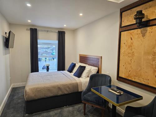 a bedroom with a bed and a table and a chair at B53 Accommodation in Maynooth
