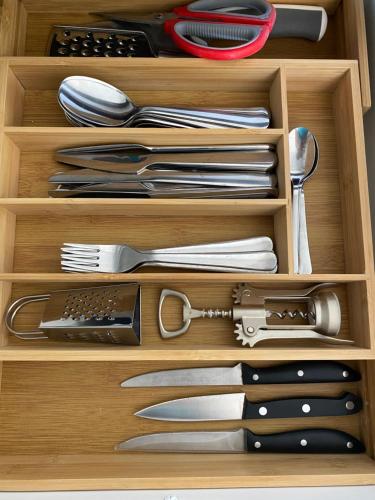 a wooden drawer filled with utensils at The Blue Beach in Sa Ràpita