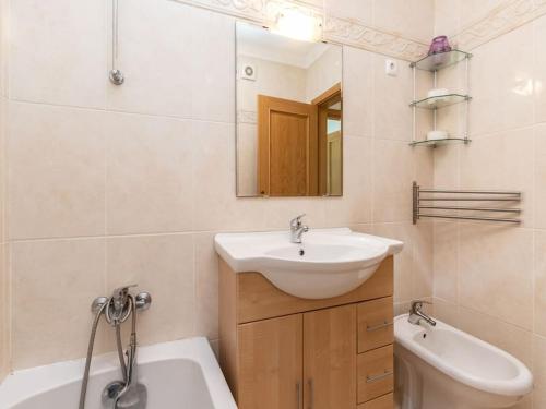 a bathroom with a sink and a tub and a toilet at NEW!! 1 Bedroom Vila Nova de Cacela in Vila Nova de Cacela
