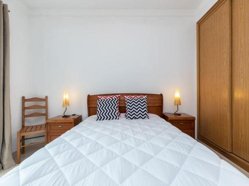 a bedroom with a large white bed with two pillows at NEW!! 1 Bedroom Vila Nova de Cacela in Vila Nova de Cacela