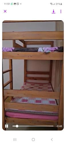 a wooden bunk bed with no one on it at ENYA APT 2A in Silang