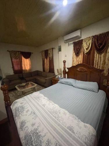 a bedroom with a bed and a living room at BMB Apartment in Georgetown