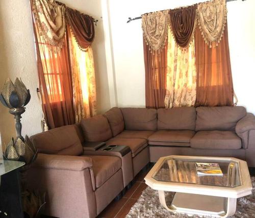 a living room with a couch and a coffee table at BMB Apartment in Georgetown