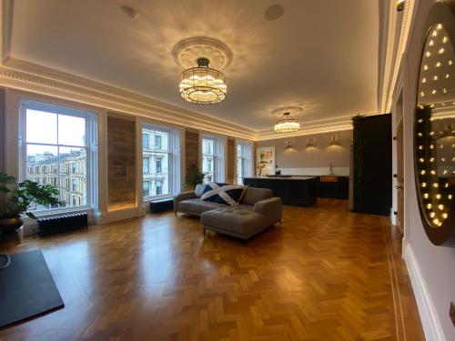 a living room with a couch and a table at Ashton View in Glasgow