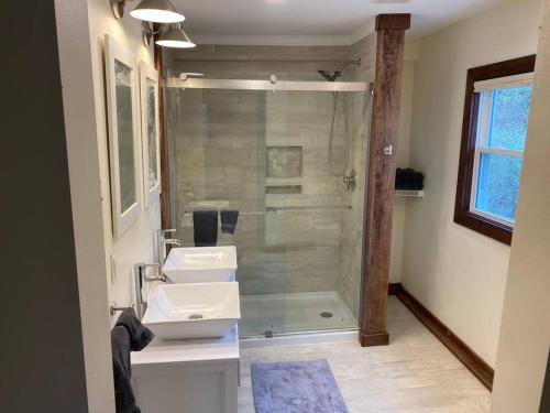 a bathroom with a glass shower and a sink at The Freedom House by Patriot Properties in Wisconsin Dells