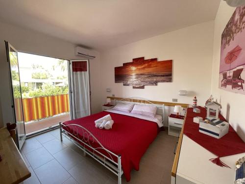 a bedroom with a bed and a large window at Casa vacanze Kastalia - Rossa in Ragusa