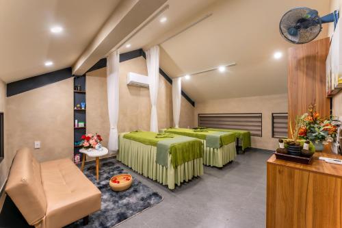 a room with two beds in a room at The Linh Seaside Villa Hoi An in Hoi An