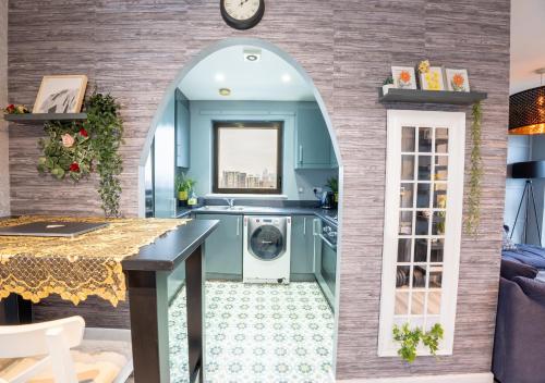a kitchen with a washer and dryer in a room at Canary Wharf Skyline Sanctuary London in London