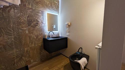 a bathroom with a sink and a mirror at hotel garni Santa Caterina in Orta San Giulio