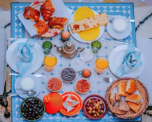 a table topped with plates of food and drinks at RIAD LAICHI in Marrakech
