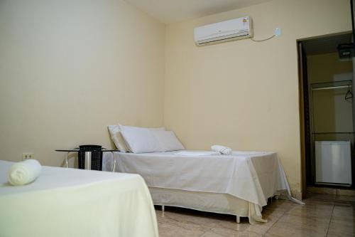 Ένα ή περισσότερα κρεβάτια σε δωμάτιο στο Hotel Santos