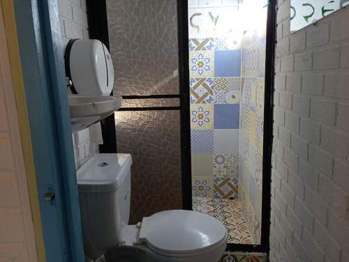 a bathroom with a toilet and a sink at Truchera San José in Belmira