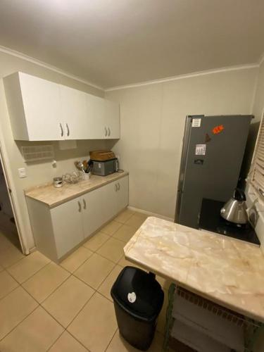 a kitchen with a refrigerator and a table in it at Arriendo casa por día in Villarrica