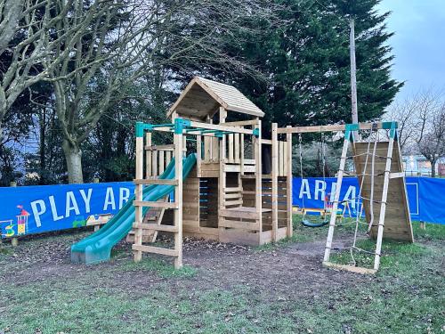 a wooden playground with a slide and a play area at Sporting Lodge Inn Middlesbrough in Middlesbrough