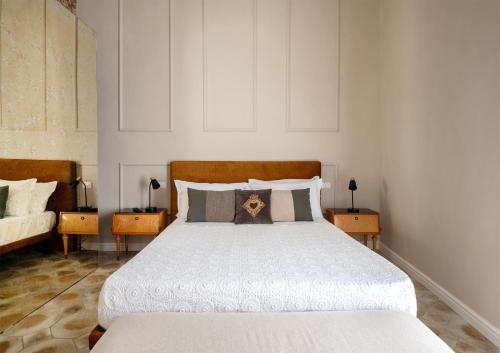 a bedroom with a large bed with white sheets and pillows at Ziolì in Noto