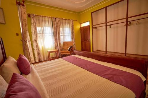 a bedroom with a large bed in a room at The Forest House - Kawuku-Bunga in Kampala