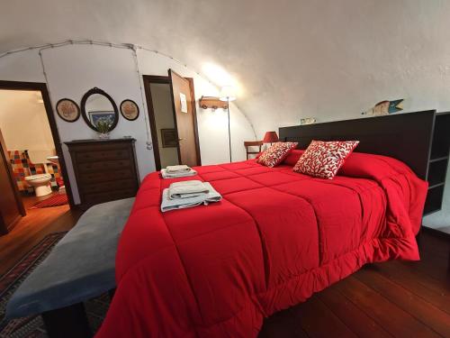 a bedroom with a large red bed with red pillows at Room in Villa Galletti Inguaggiato in Bagheria