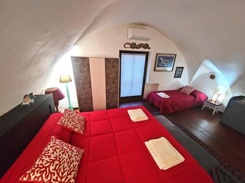 a living room with a red couch and a bed at Room in Villa Galletti Inguaggiato in Bagheria