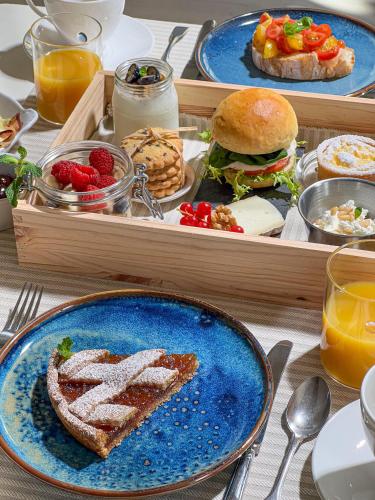 a tray of food with a plate of food with a sandwich and aurger at Tenuta d'Arbia, Siena in Monteroni dʼArbia