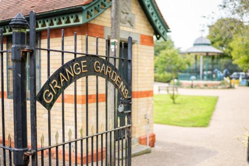 a gate to anance garden with a sign on it at Smart TV | WiFi | Free Parking in Cardiff