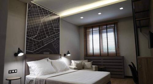 a bedroom with a large bed and a window at Avenue Luxury Apartments in Alexandroupoli
