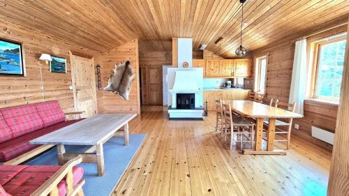 a kitchen and living room with a table and a stove at Ferienhaus in Sand mit Offenerem Kamin in Sand