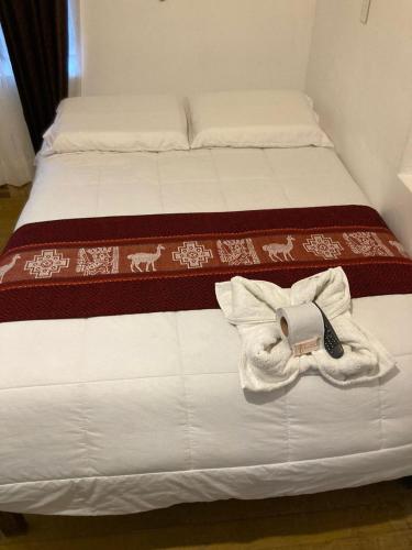 a pair of beds with towels and underwear on them at Inca viewpoint in Ollantaytambo