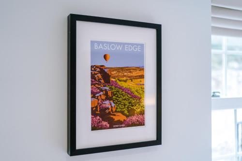 a framed poster of a hot air balloon and flowers at Rock Mill - Deluxe Studio Apartments in Stoney Middleton