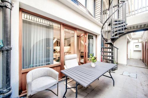 a patio with a table and chairs and a staircase at 4 guests | Smart TV | Attractions in London