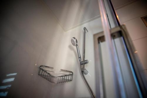 głowicę prysznicową i kosz na ścianie w obiekcie Hausboot Malibu Sunrise w mieście Klitten