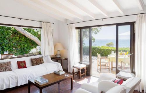 Sala de estar con sofá blanco y vistas al océano en Casa Morant On The Promenade Mhm en Cala Ratjada