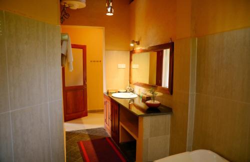 a bathroom with a sink and a mirror at Tropical Retreat in Unawatuna