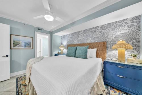 a bedroom with a large bed and a blue dresser at Gulf Dunes 305 Coastal Dream in Fort Walton Beach