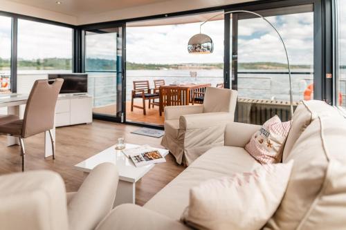 a living room with a couch and a table at Hausboot Hering - LP7 in Höxter
