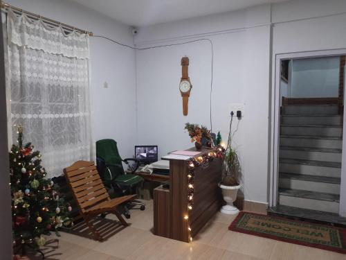an office with a christmas tree and a desk at Shanti Sojourn in Shillong