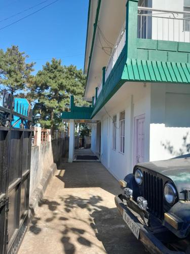 an old car parked in front of a building at Shanti Sojourn in Shillong