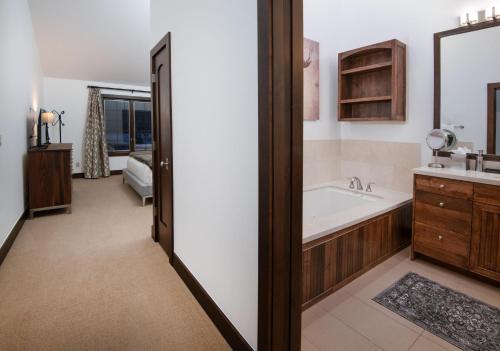 a bathroom with a tub and a sink at Wildflower Place Unit 5 in Edwards