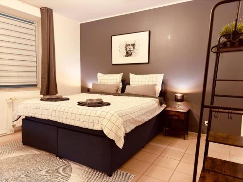 a bedroom with a bed in a room with a ladder at Loft with Gym - Kitchen / WiFi / Free Parking in Berlin