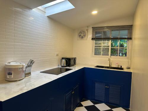 a kitchen with a blue counter and a sink at Luxury Thai Escape in Chiang Mai