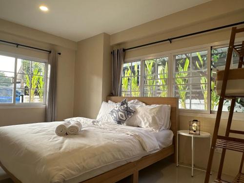 a bedroom with a bed with two stuffed animals on it at Luxury Thai Escape in Chiang Mai